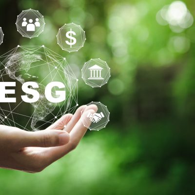 ESG icon concept in the hand for environmental, social, and governance in sustainable and ethical business on the Network connection on a green background.